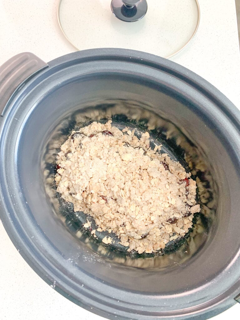 sourdough cobbler topping added into slow cooker on top of cherry