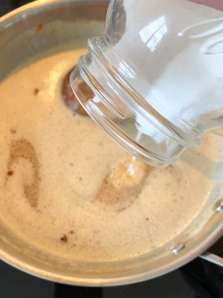 adding ingredients to roux for sauce