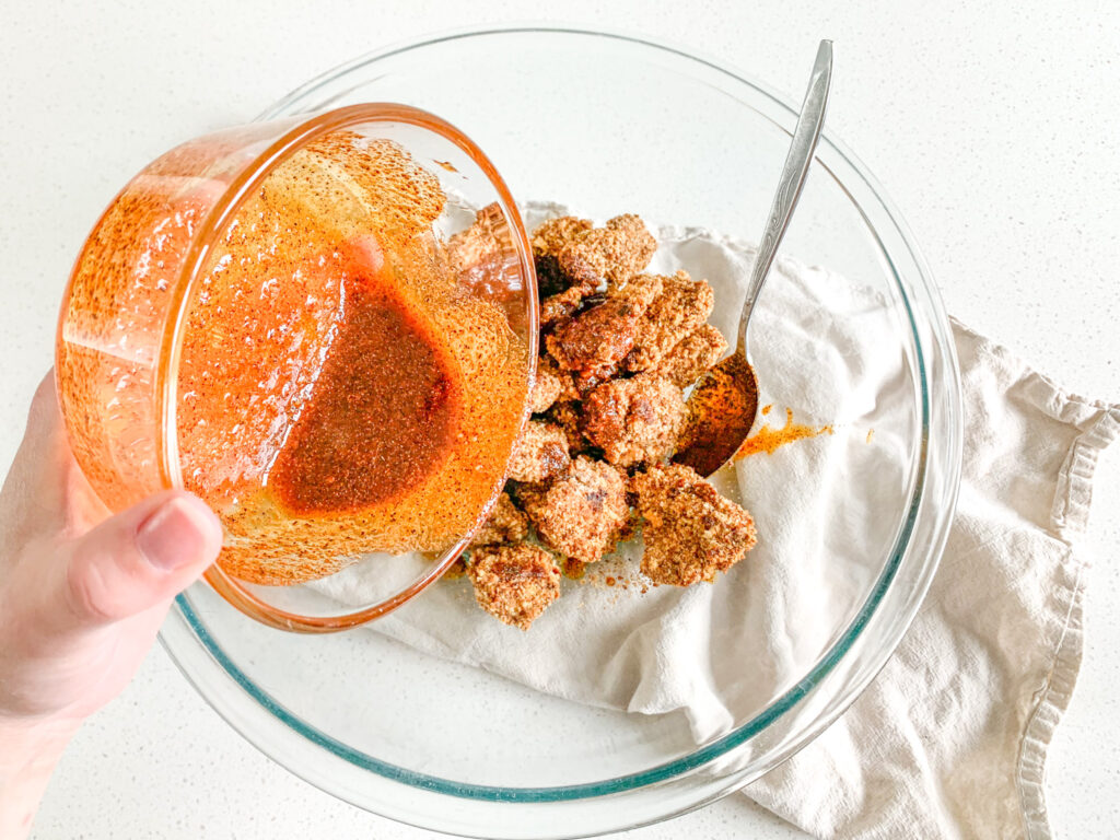 pour nashville hot seasoning mixture over freshly baked chicken