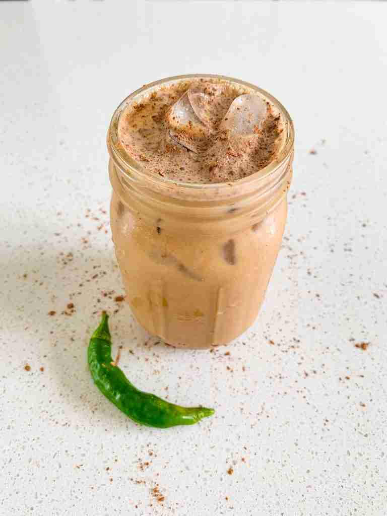 mason jar of coffee with a pepper next to it