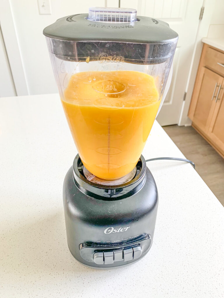 mango getting blended in a blender