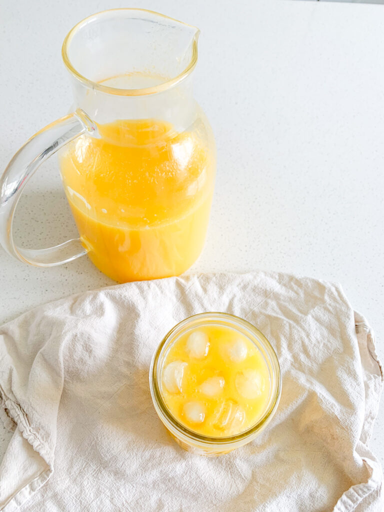 freshly made homemade mango lemonade poured in a glass