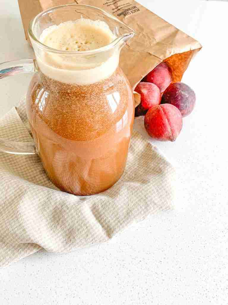 freshly made peach sweet tea in a pitcher