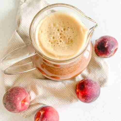 freshly made peach sweet tea in a pitcher