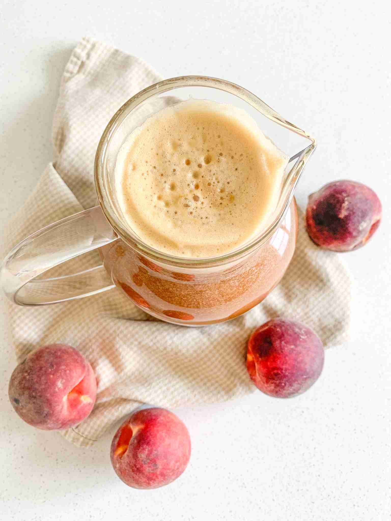 freshly made peach sweet tea in a pitcher