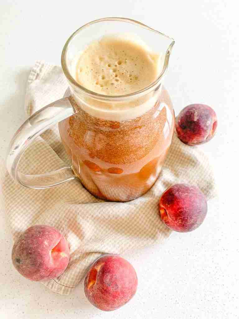 freshly made peach sweet tea in a pitcher