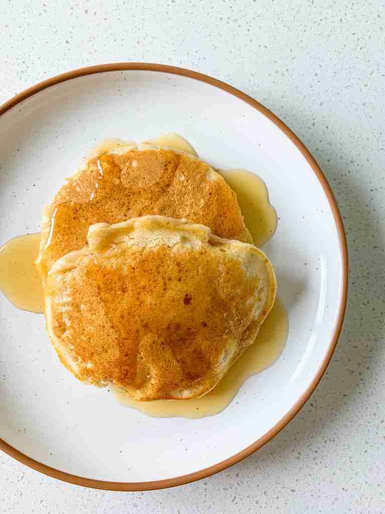 stack of pancakes on a plate with syrup