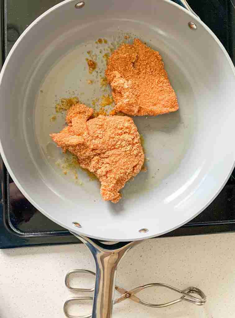 breaded chicken in a frying pan