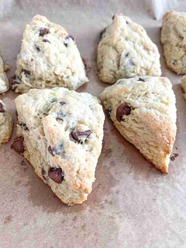 Freshly baked sourdough chocolate chip scones on a tray
