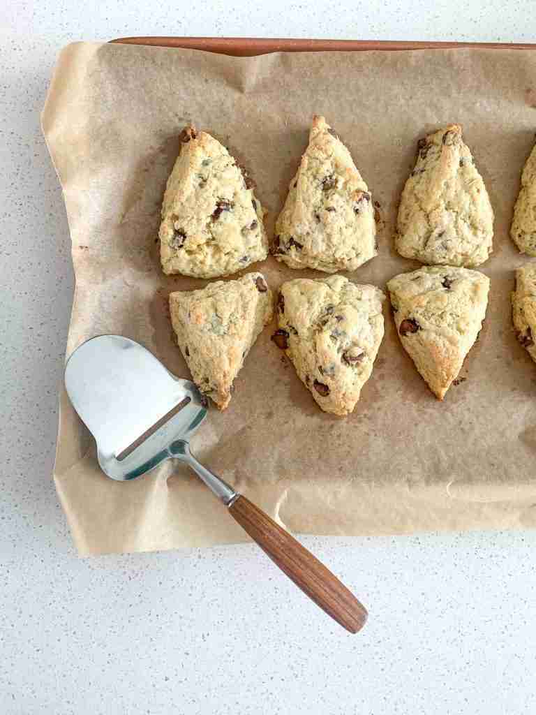 Freshly baked sourdough chocolate chip scones on a tray
