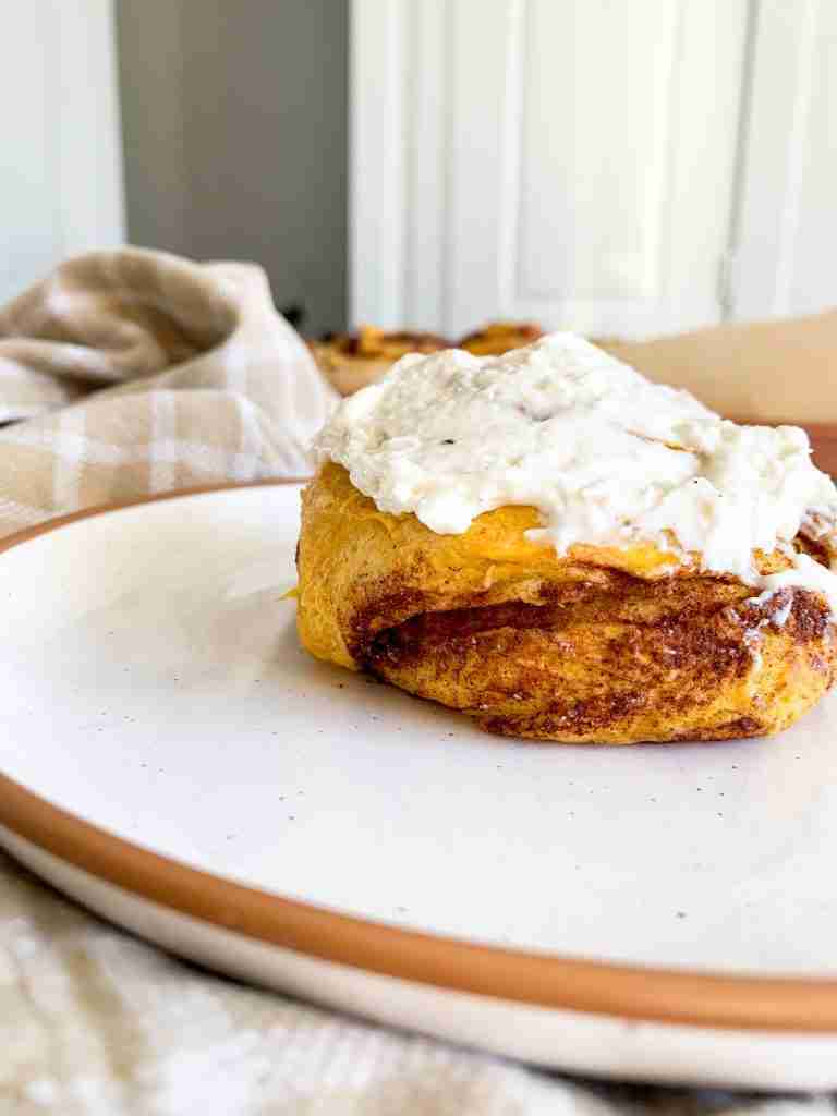 up close cinnamon roll with frosting