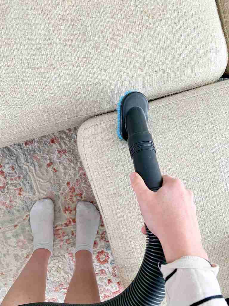 sweeper attachment sweeping the couch