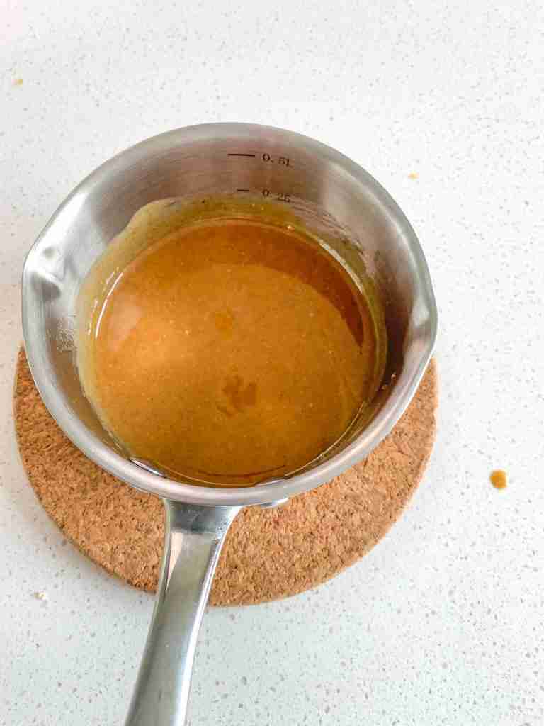 peanut butter honey mixture whisked together for snack mix