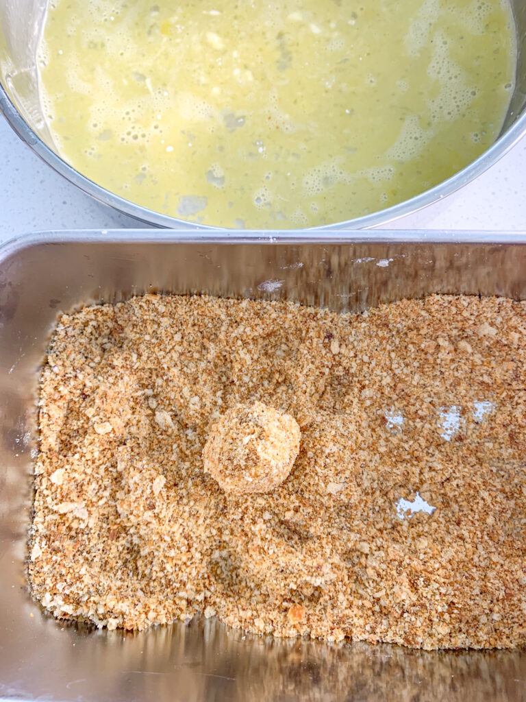 breading mozzerella in breadcrumbs