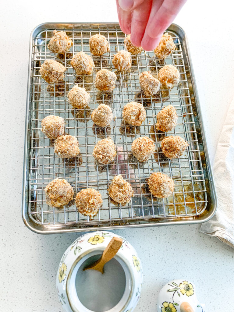 sprinkling freshly baked mozzarella balls with salt