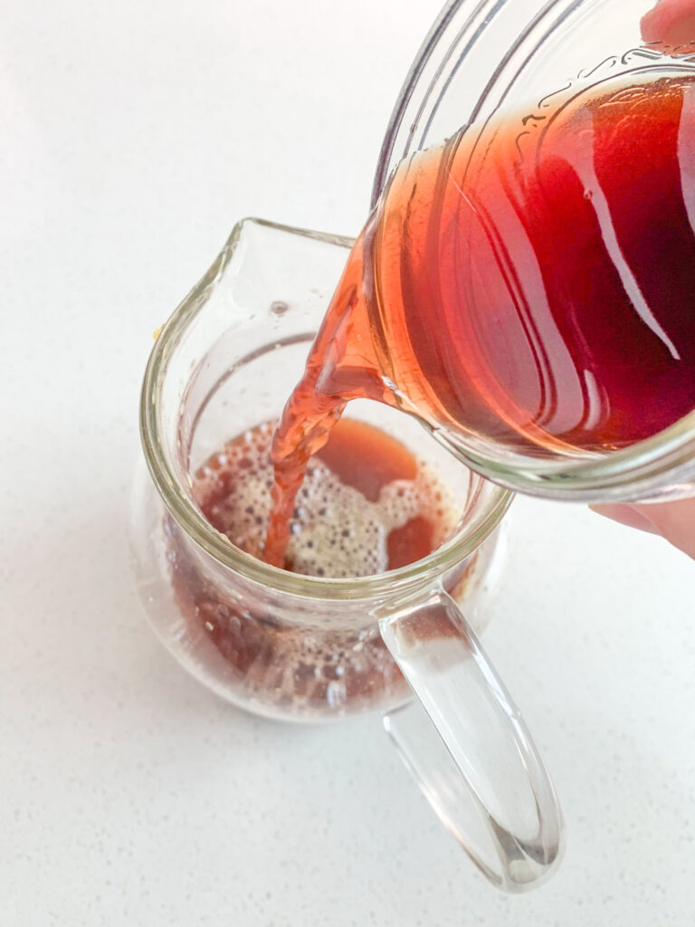 adding pomegranate juice into pitcher