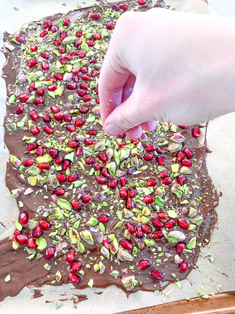 sprinkling sea salt on chocolate bark