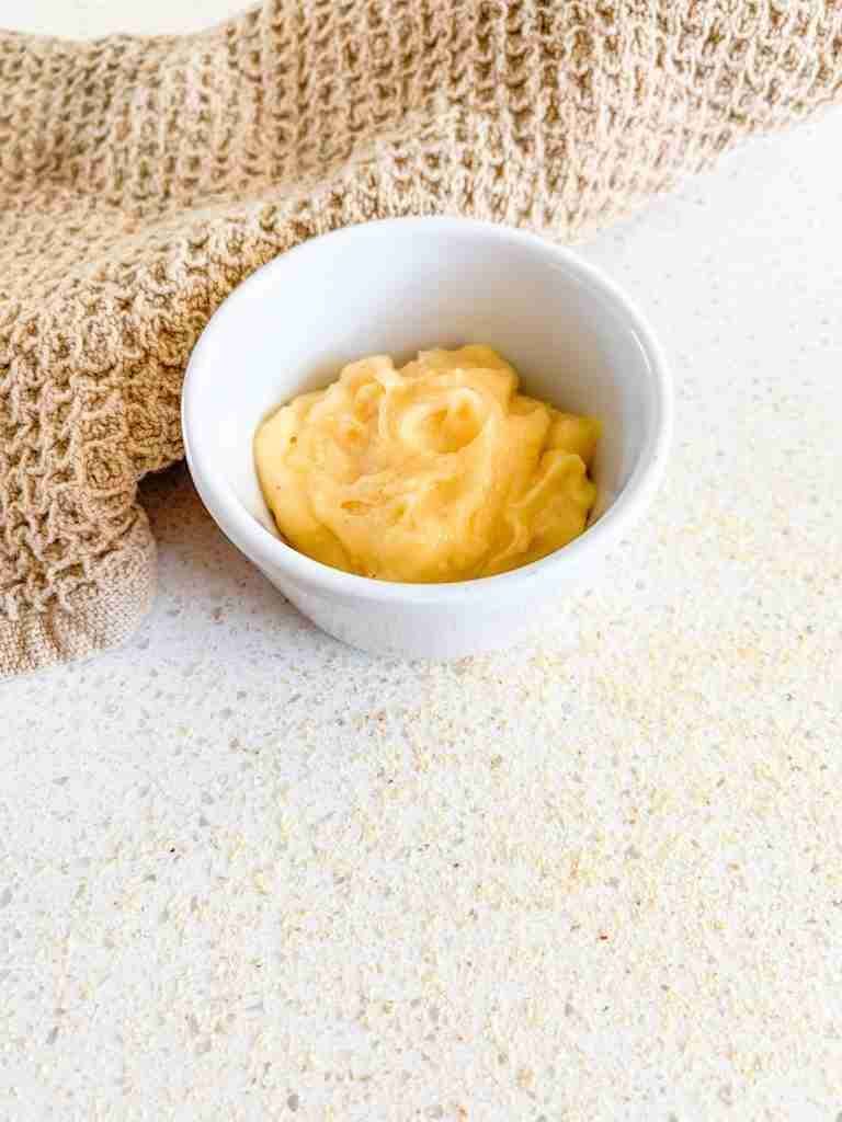 small bowl with butter inside and a rag around it