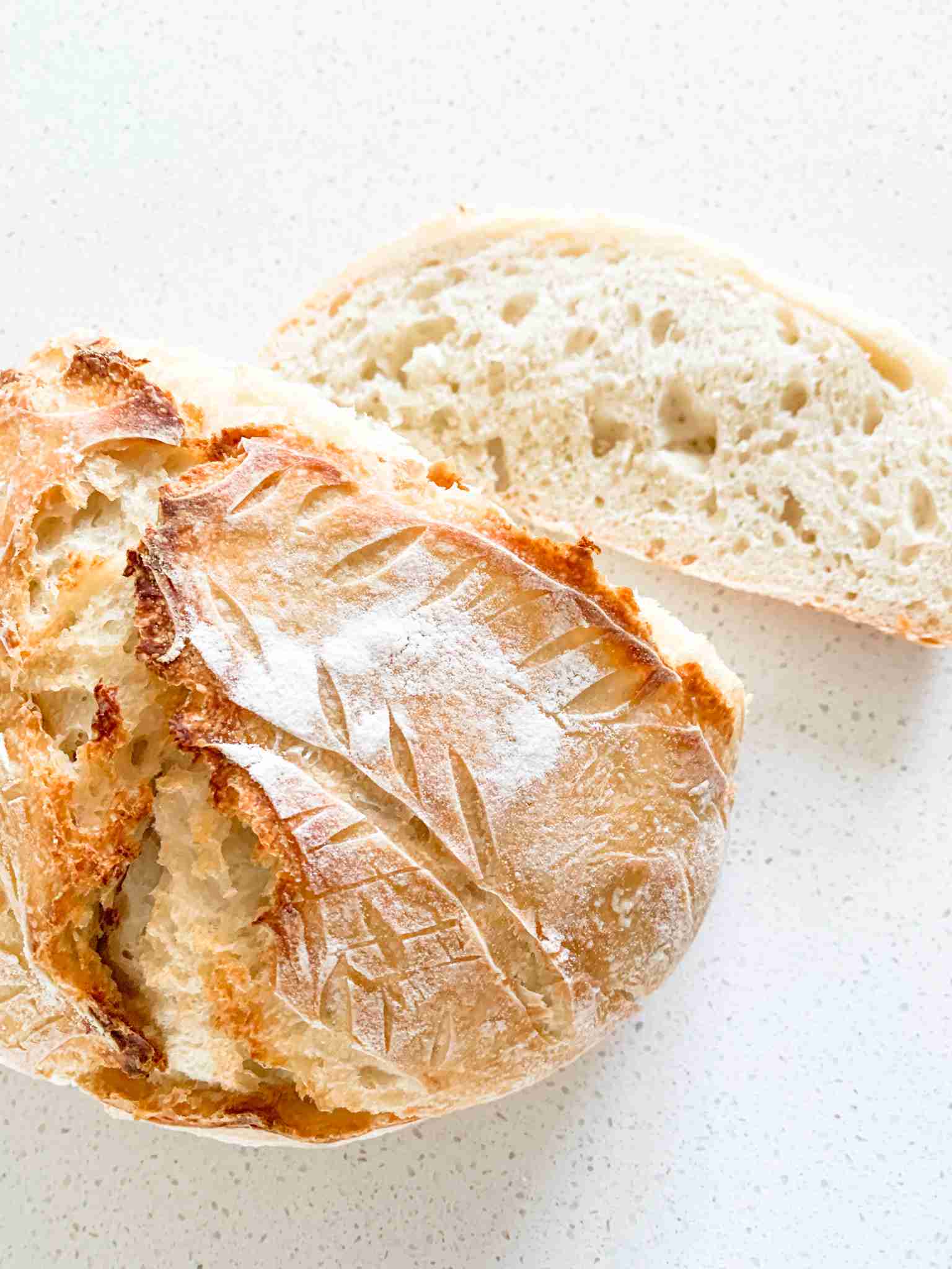 loaf of bread with a slice sitting beside it
