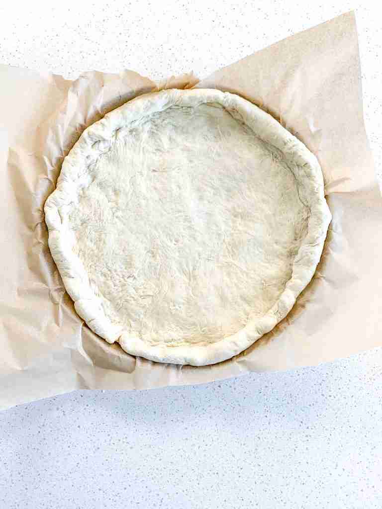shaped pizza dough ready to bake