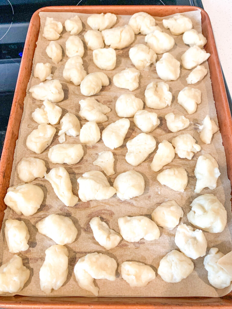 sourdough pretzel bites dough on a sheet pan ready for baking