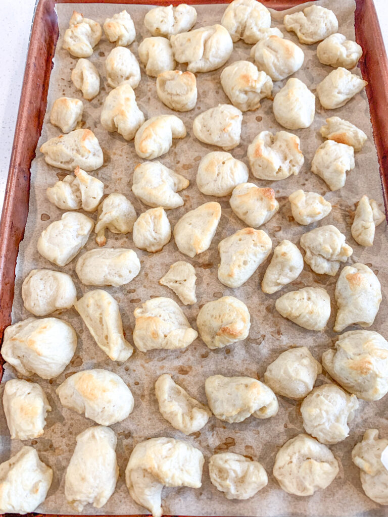 freshly baked sourdough pretzel bites on a sheet pan