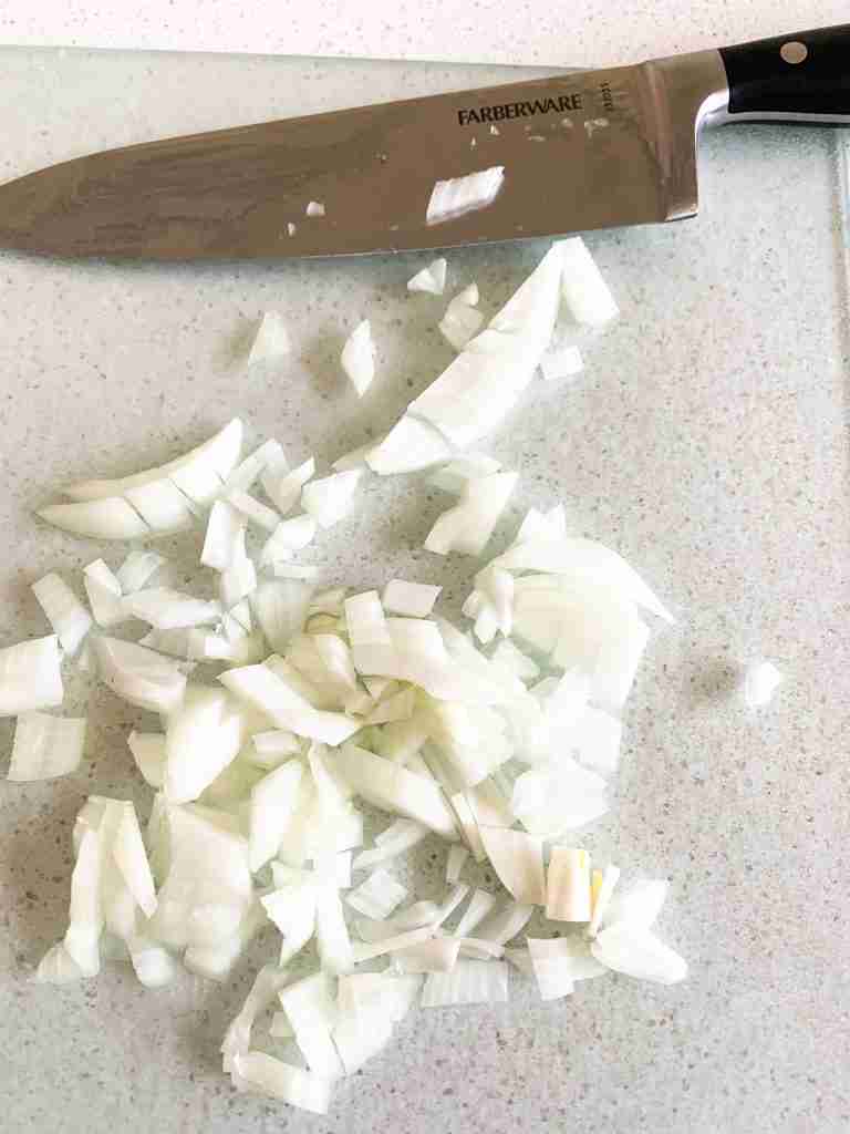 knife sitting by diced onions