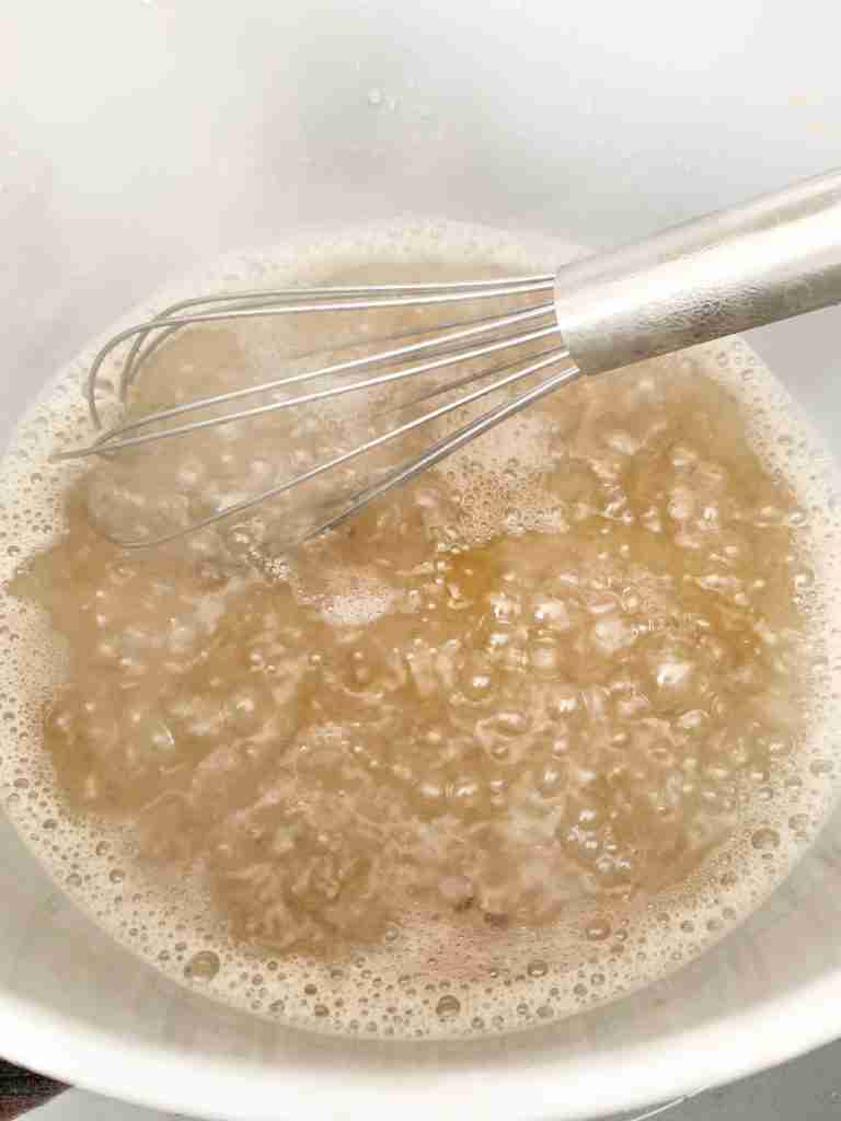 whisk stirring bubbling sugar water