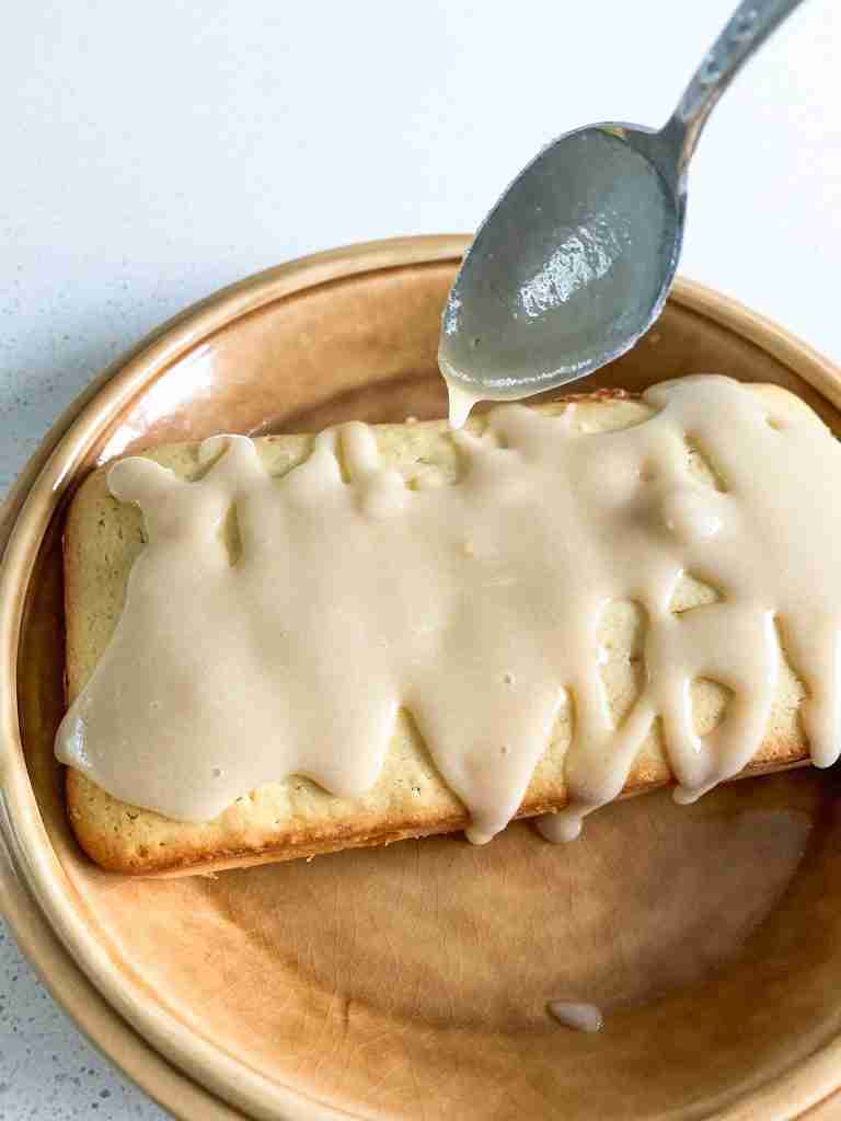 pouring glaze over a cake