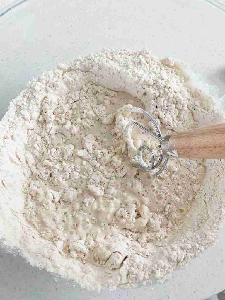 whisk combining flour into a mixture