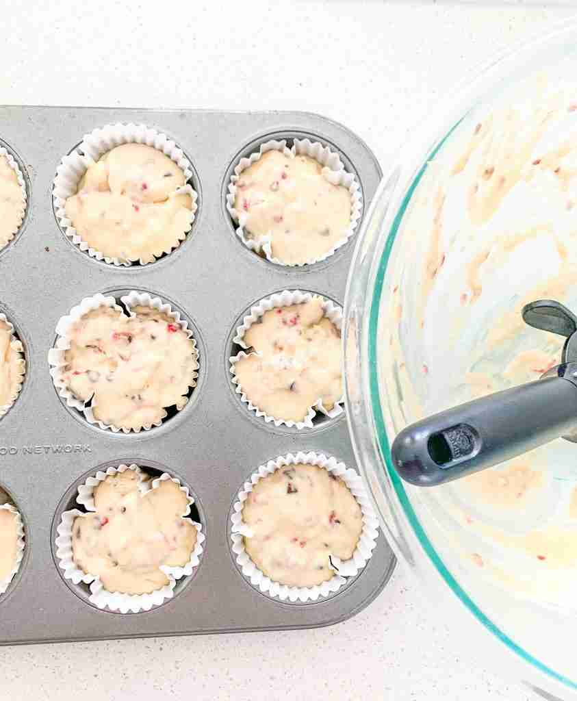 muffin liners being filled with batter