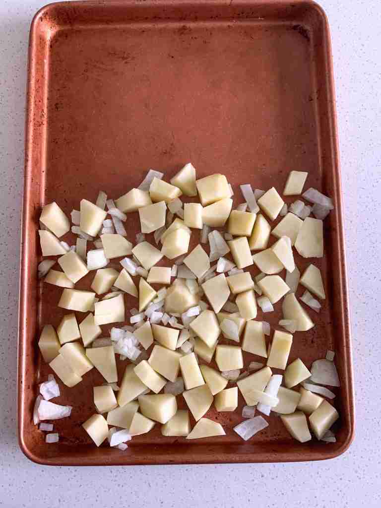potatoes and onions on a sheet pan