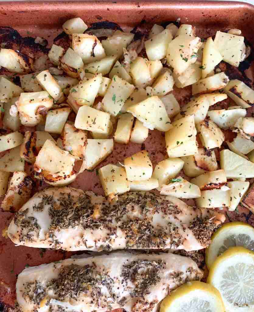 sheet pan full of lemons, chicken, and potatoes