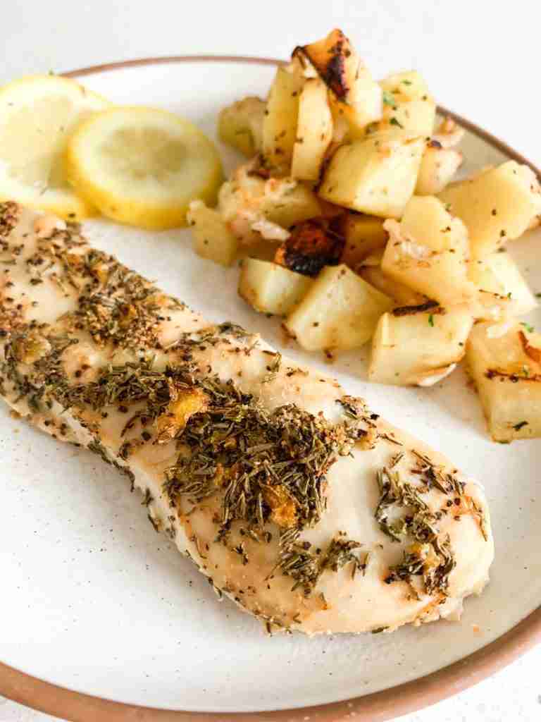 chicken, potatoes, and lemons on a plate