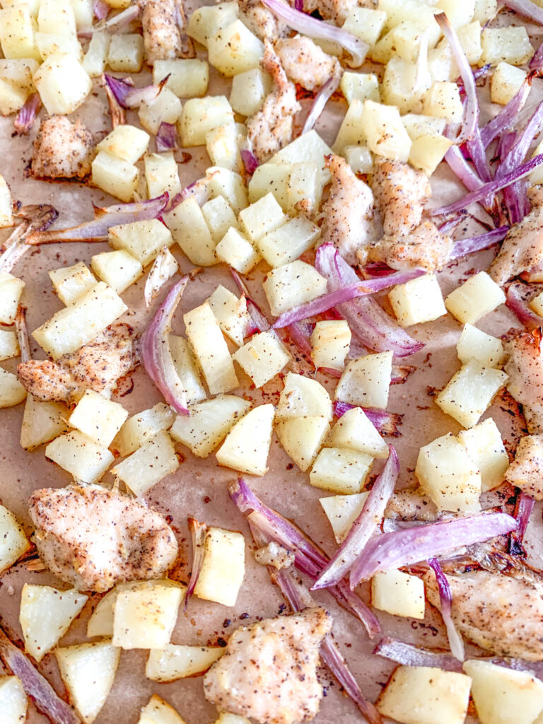 lemon chicken and potatoes spread out on sheet pan baked