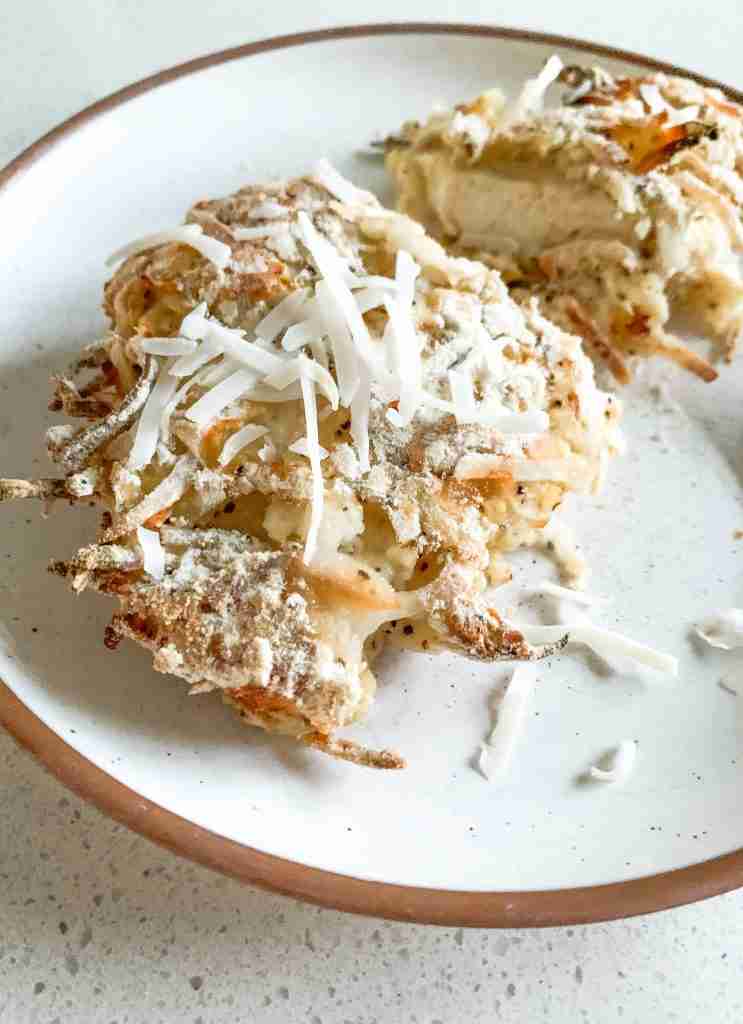 piece of chicken with coconut on top on a plate