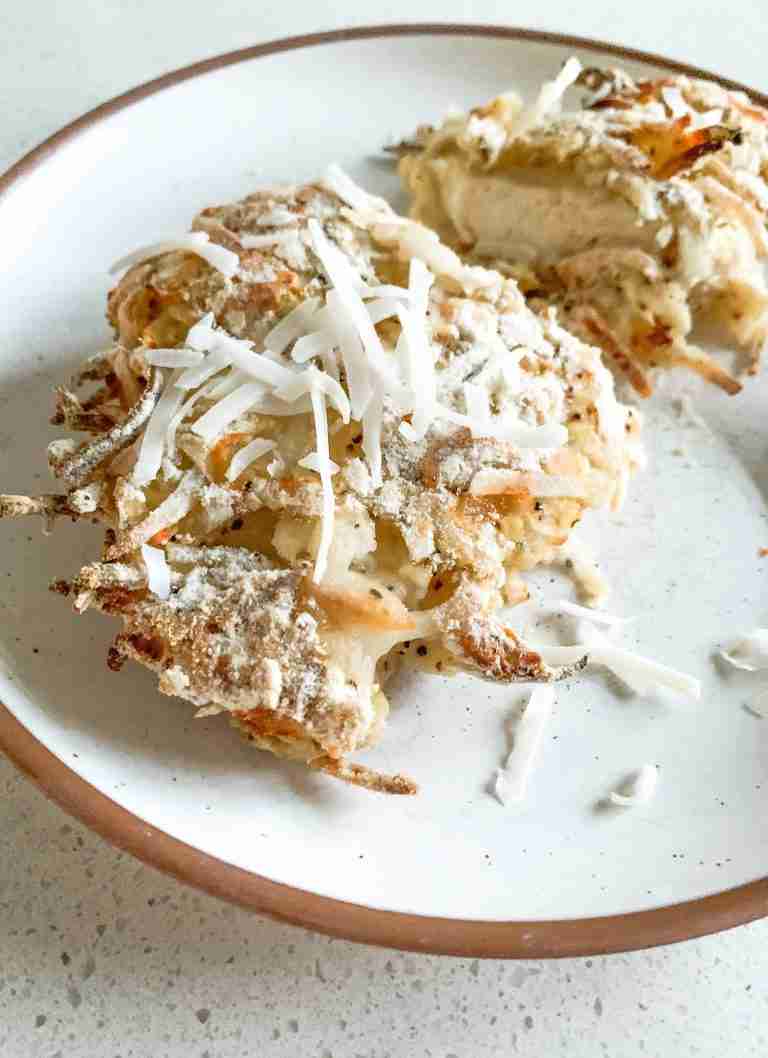 piece of chicken with coconut on top on a plate