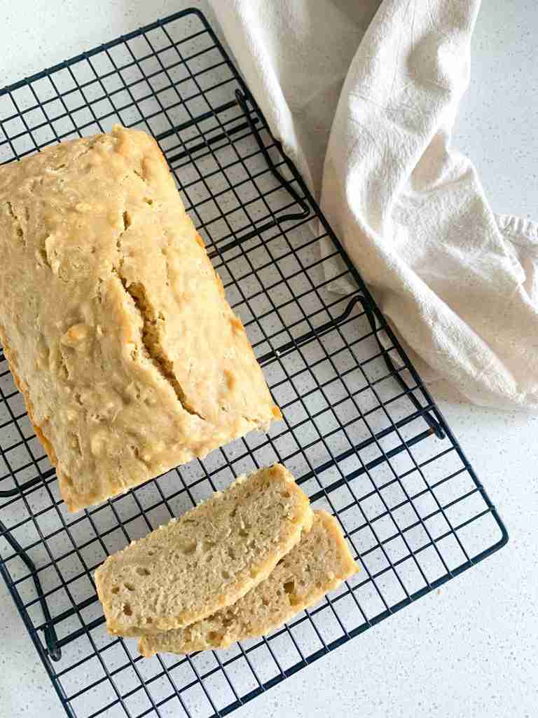 loaf of bread on a wire rack and slices cut off