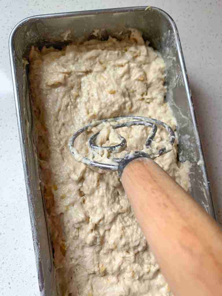 bread whisk smoothing out dough batter in a pan