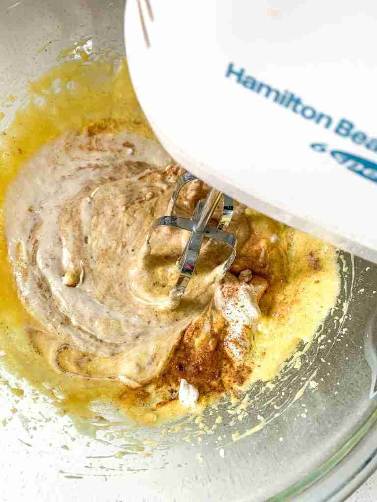 ingredients being mixed with an electric mixer