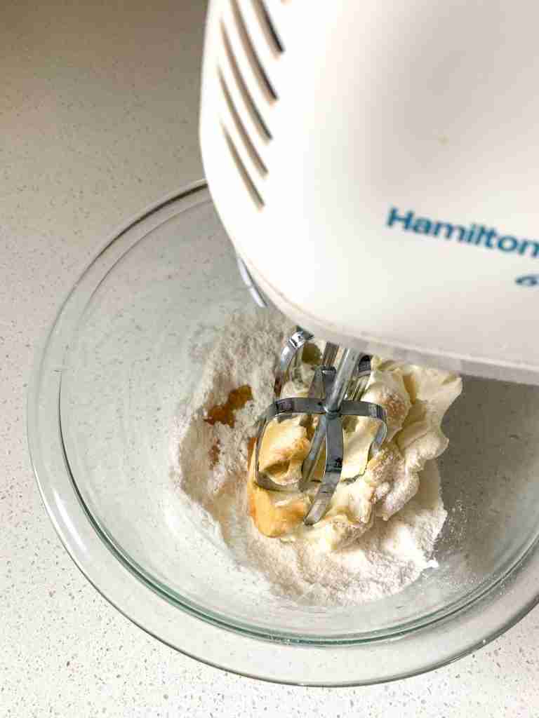 whipping together frosting ingredients