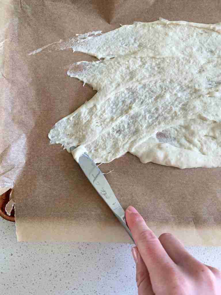 hand spreading starter on a paper