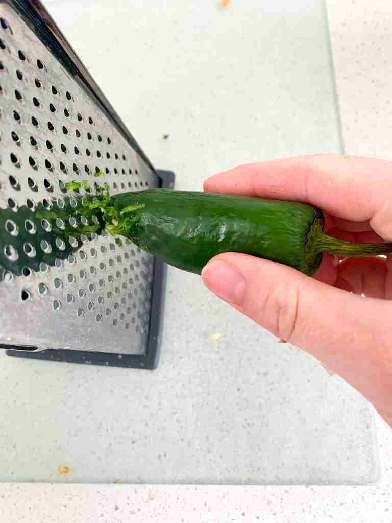 hand grating a jalapeno