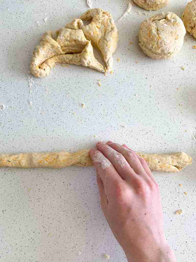 hand rolling biscuit dough