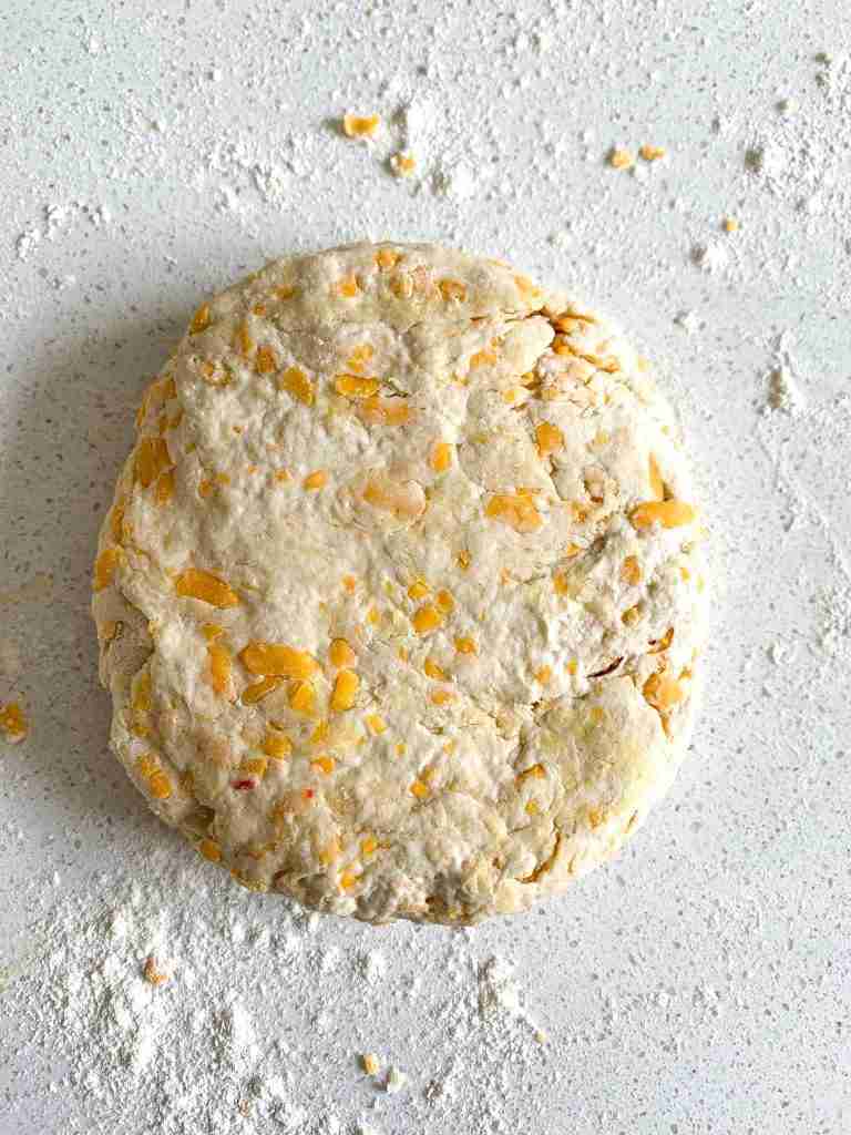 dough being shaped into a round circle