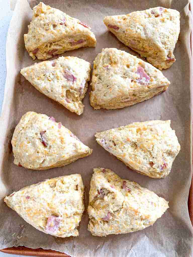 scones with cheese and ham in them on a baking sheet