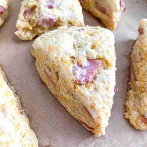 scones with cheese and ham in them on a baking sheet