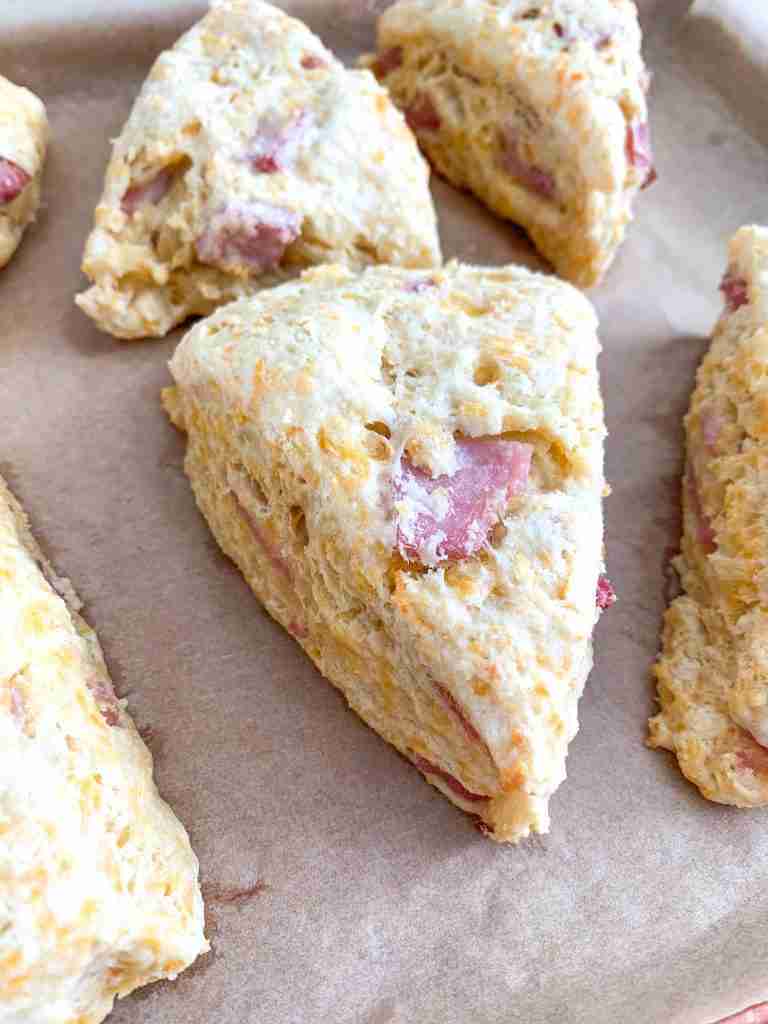 scones with cheese and ham in them on a baking sheet