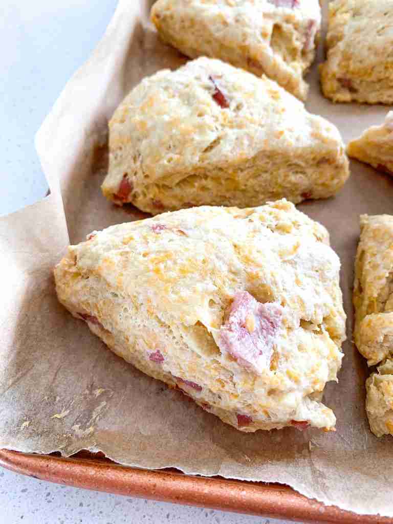scones with cheese and ham in them on a baking sheet