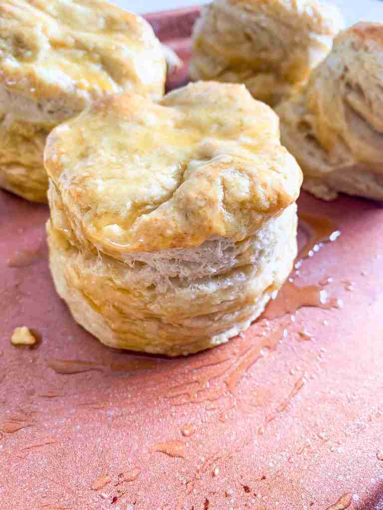 biscuit sitting on a tray with honey all over it